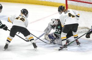 Proctor/Hermantown goaltender Abby Pajari (32) makes a save in the second period under pressure from Warroad's Abbey Reule 912) and Reanna Smith (4).  Photo by Cheryl A. Myers, SportsEngine