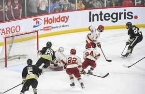 Andover forward Logan Gravink (22), far right, scores the game-winning goal against Maple Grove during the second overtime in the Class 2A Boys Hockey State Championship Game Saturday, March 12, 2022 at the Xcel Energy Center in St. Paul, Minn. ] AARON LAVINSKY • aaron.lavinsky@startribune.com